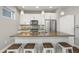 Modern kitchen with white cabinets, stainless steel appliances, and a spacious island with bar seating at 1245 Utica St # 105, Denver, CO 80204