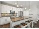Stylish kitchen featuring white cabinetry, stainless steel appliances, and a large island with seating at 1245 Utica St # 105, Denver, CO 80204