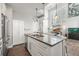 Modern kitchen seamlessly blends with the living area, featuring a large island with stainless steel appliances at 1245 Utica St # 105, Denver, CO 80204