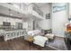 Open-concept living room and kitchen with modern furnishings, a cozy sofa, and an adjacent dining area at 1245 Utica St # 105, Denver, CO 80204