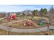 Community playground with slides, swings, and climbing structures, situated near modern housing at 1245 Utica St # 105, Denver, CO 80204