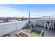 Relaxing rooftop deck features a fire pit, seating, and views of the city skyline, perfect for outdoor entertaining at 1245 Utica St # 105, Denver, CO 80204
