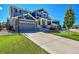 Two-story house with gray siding, brick accents, and a landscaped front yard with basketball hoop at 22528 E Layton Cir, Aurora, CO 80015