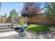 Landscaped backyard featuring a deck and artificial turf at 27886 E 8Th Pl, Aurora, CO 80018