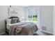 Cozy bedroom featuring a large window overlooking a green lawn at 7440 S Blackhawk St # 14-103, Englewood, CO 80112
