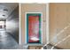 Close-up of a unit entry door featuring a teal frame and decorative glass at 7440 S Blackhawk St # 14-103, Englewood, CO 80112