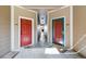 Inviting hallway with two unit entry doors and neutral color scheme at 7440 S Blackhawk St # 14-103, Englewood, CO 80112