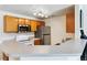 Bright kitchen with stainless steel appliances, light wood cabinetry, and modern lighting at 7440 S Blackhawk St # 14-103, Englewood, CO 80112