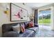 Bright living room featuring a large sofa, modern artwork, and sliding glass doors to patio at 7440 S Blackhawk St # 14-103, Englewood, CO 80112
