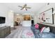 Cozy living room featuring a sofa, ceiling fan, and open view to the kitchen at 7440 S Blackhawk St # 14-103, Englewood, CO 80112