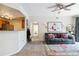 Open concept living area with kitchen access, sofa, and neutral carpet at 7440 S Blackhawk St # 14-103, Englewood, CO 80112