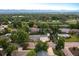 Aerial view of a neighborhood with lush greenery and mountain views in the distance at 6243 S Elati St, Littleton, CO 80120