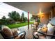 Inviting covered back porch with comfortable seating and a view of the backyard at 6243 S Elati St, Littleton, CO 80120