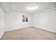 Finished basement featuring neutral carpet and a window well providing natural light at 6243 S Elati St, Littleton, CO 80120
