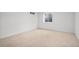 Empty basement offers a blank canvas with neutral carpet and a small window at 6243 S Elati St, Littleton, CO 80120