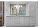 Bright bathroom featuring modern double sink vanity, updated lighting, and stylish finishes at 6243 S Elati St, Littleton, CO 80120