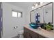 Stylish bathroom featuring a blue bowl sink, modern vanity, and updated fixtures at 6243 S Elati St, Littleton, CO 80120
