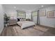 Bedroom with neutral decor, two side tables and lamps, and two windows providing ample natural light at 6243 S Elati St, Littleton, CO 80120