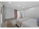 Spacious bedroom with a sliding barn door and a view to an en suite bathroom at 6243 S Elati St, Littleton, CO 80120