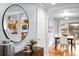 Open dining area featuring hardwood floors and views into kitchen through a round mirror at 6243 S Elati St, Littleton, CO 80120