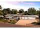 Ranch-style home featuring a three-car garage, mature landscaping, and a welcoming front porch at 6243 S Elati St, Littleton, CO 80120