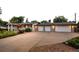 Well-maintained home featuring a large driveway, three-car garage, and manicured landscaping at 6243 S Elati St, Littleton, CO 80120