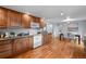 Bright kitchen and dining area with hardwood floors and matching wood cabinetry at 6243 S Elati St, Littleton, CO 80120