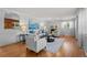 Bright living room featuring hardwood floors, a fireplace, and stylish, comfortable seating at 6243 S Elati St, Littleton, CO 80120