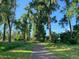 Scenic view of a paved walking path surrounded by lush trees and greenery at 6243 S Elati St, Littleton, CO 80120