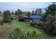A beautiful, expansive property with mature trees surrounding the modern-style house and long driveway at 8092 Ponderosa Ln, Parker, CO 80138
