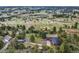 Wide aerial view showing the property including the house, garage, driveways and surrounding lush greenery at 8092 Ponderosa Ln, Parker, CO 80138