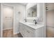 Stylish bathroom features a double sink vanity with LED mirror and modern fixtures at 8092 Ponderosa Ln, Parker, CO 80138