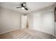 A well-lit bedroom with ample closet space, carpeting, and a modern ceiling fan at 8092 Ponderosa Ln, Parker, CO 80138