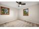 This well-lit bedroom has carpeting, modern ceiling fan, and sunlit windows at 8092 Ponderosa Ln, Parker, CO 80138