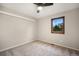 Carpeted bedroom featuring a ceiling fan and natural light from a window at 8092 Ponderosa Ln, Parker, CO 80138