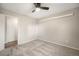 Bedroom with neutral carpet and paint, ceiling fan, and a standard closet door at 8092 Ponderosa Ln, Parker, CO 80138