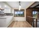 Charming dining nook featuring hardwood floors, bright windows, and views of the surrounding scenery at 8092 Ponderosa Ln, Parker, CO 80138