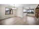 Bright open-concept dining room and kitchen area with hardwood floors and modern lighting at 8092 Ponderosa Ln, Parker, CO 80138