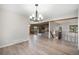 Spacious dining room with hardwood floors, modern chandelier, and an open floor plan at 8092 Ponderosa Ln, Parker, CO 80138