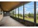 Covered porch with wood deck, floor-to-ceiling windows offering expansive views of the property at 8092 Ponderosa Ln, Parker, CO 80138