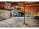 A large garage with a dirt floor and an open door that allows a glimpse of the landscape outside at 8092 Ponderosa Ln, Parker, CO 80138