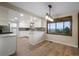 Well-lit kitchen nook with hardwood floors, views of the outside, and crisp white cabinetry at 8092 Ponderosa Ln, Parker, CO 80138