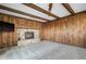 Living room features wood paneling, fireplace with stone surround, and neutral carpet at 8092 Ponderosa Ln, Parker, CO 80138