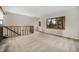 Carpeted room with natural light, wooden railing, walk-out door and scenic views through a large window at 8092 Ponderosa Ln, Parker, CO 80138