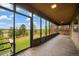 Bright sunroom with floor-to-ceiling windows showcases panoramic views of the surrounding landscape at 8092 Ponderosa Ln, Parker, CO 80138