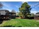 Private backyard with a large, well-manicured lawn, mature trees, and a cozy deck, offering a tranquil outdoor retreat at 879 E 133Rd Ave, Thornton, CO 80241