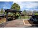 A cozy backyard deck with a pergola, outdoor seating, and a view of the lush green lawn at 879 E 133Rd Ave, Thornton, CO 80241