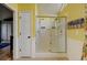 Bathroom featuring a glass enclosed shower with dual shower heads and built in bench at 879 E 133Rd Ave, Thornton, CO 80241