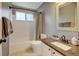 Bathroom features a shower-tub, granite countertop, and framed mirror at 879 E 133Rd Ave, Thornton, CO 80241