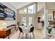 Bright dining area with high ceilings, modern lighting, and open access to kitchen at 879 E 133Rd Ave, Thornton, CO 80241